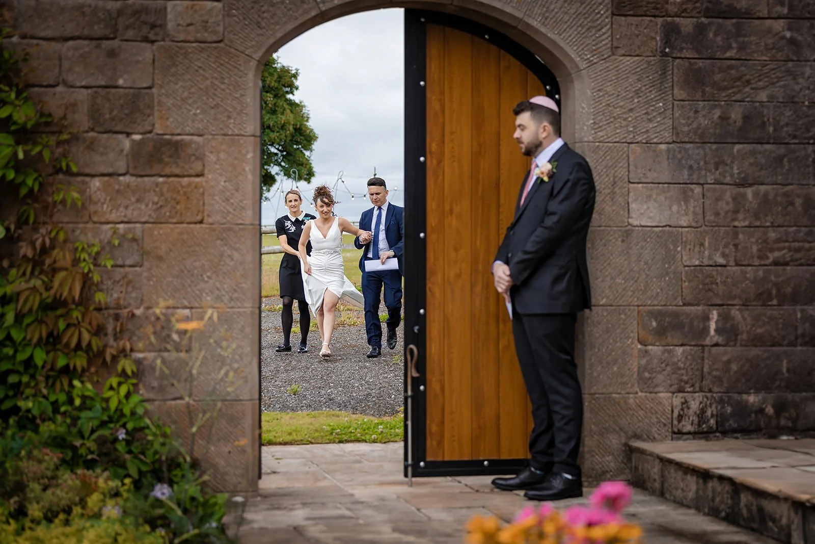 groom waits for bride in secret garden at heaton house farm in macclesfield