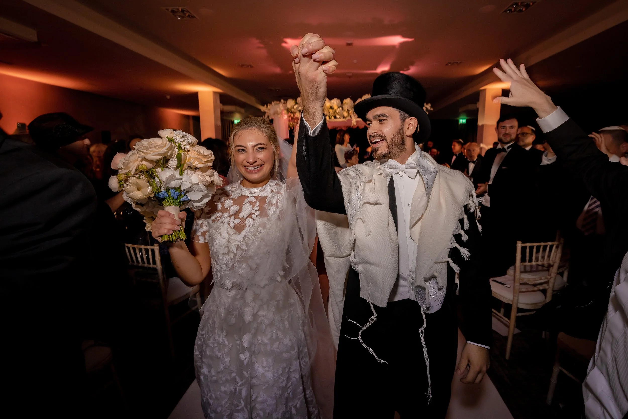 bride and groom leave their jewish chuppah wedding ceremony
