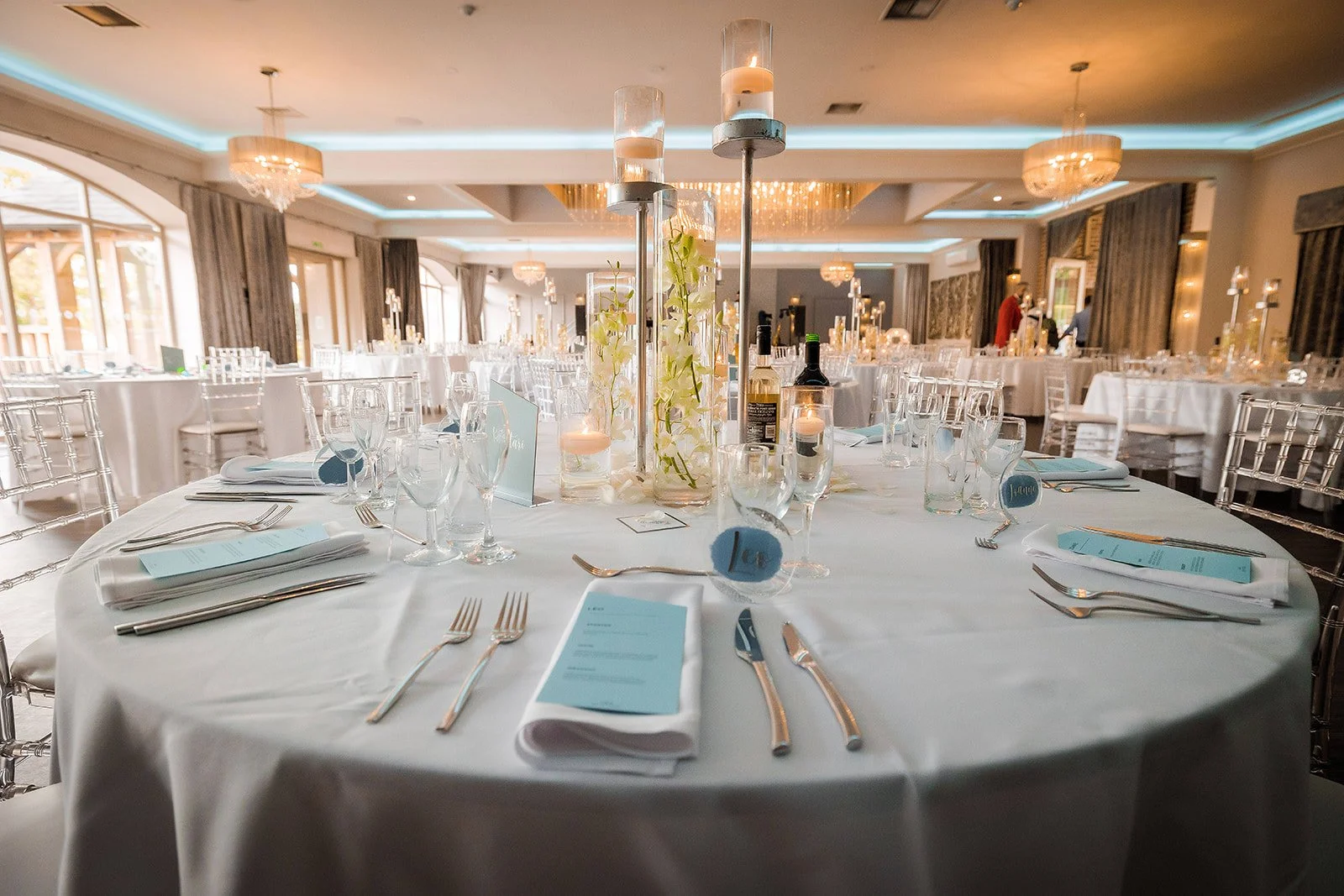 Merrydale Manor wedding reception tables set with blue menus and candles – fine art wedding photographer North West