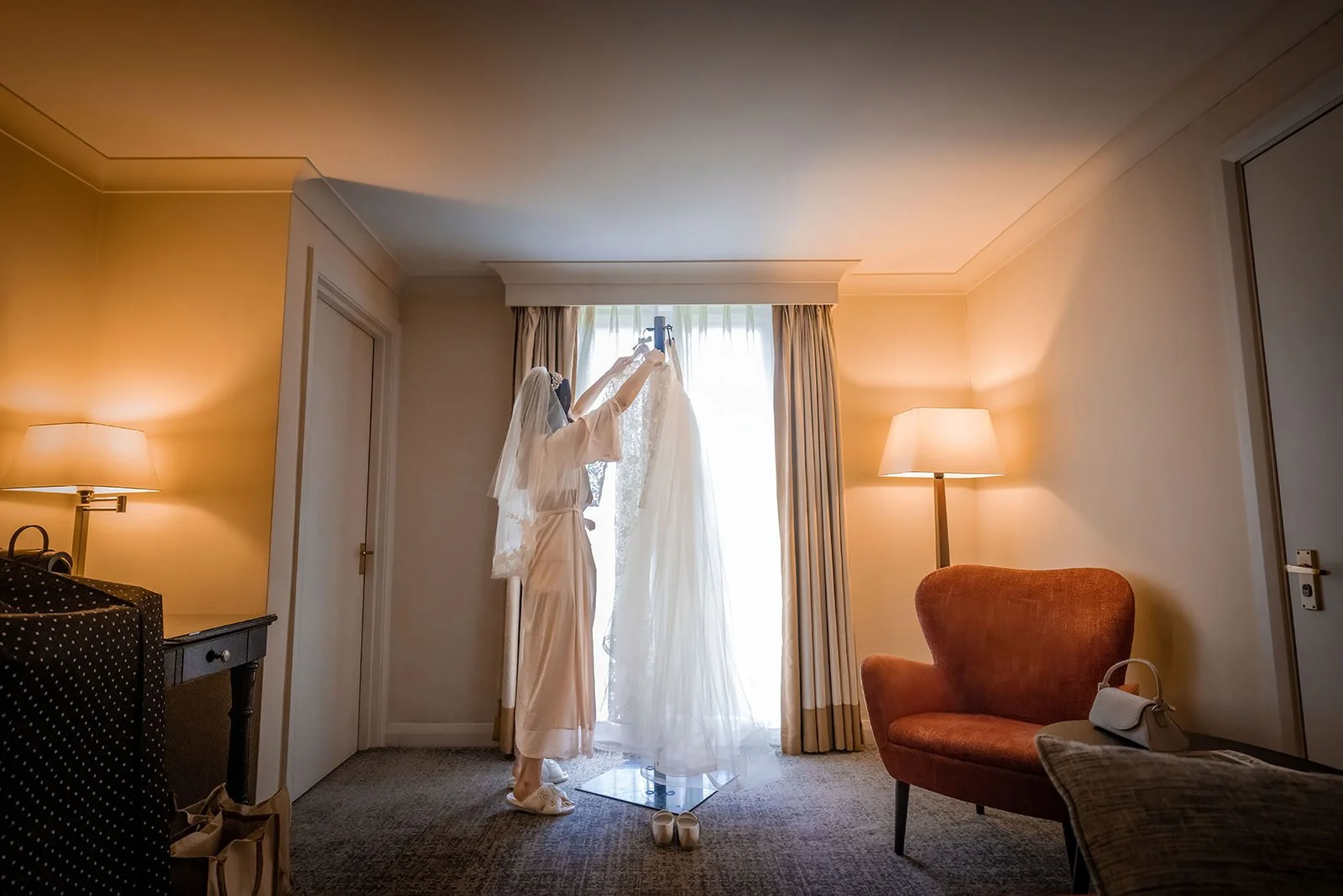 bride hanging up dress during bridal prep at worsley marriott hotel
