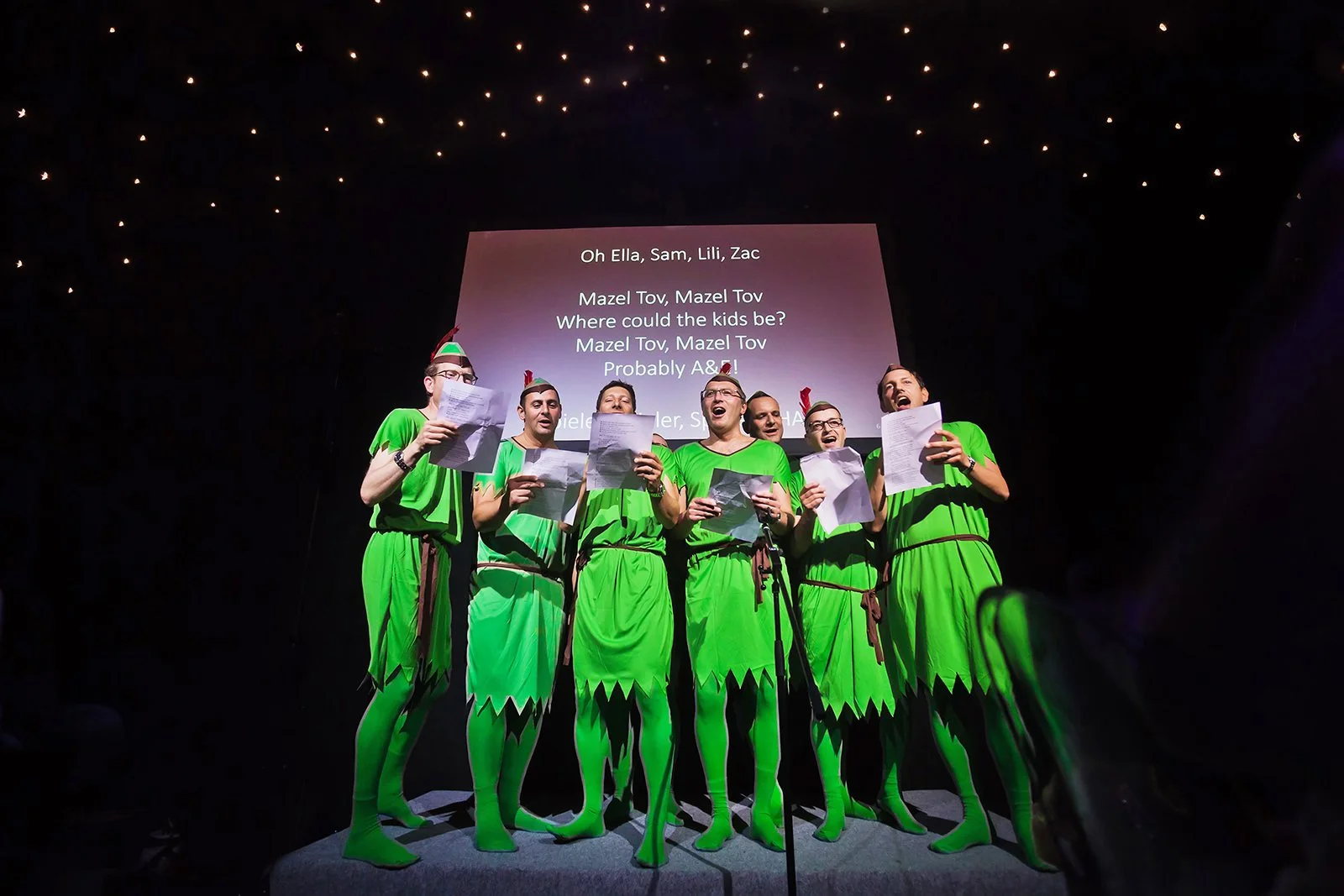 Funny barmitzvah speech with men in fancy dress peter pan costumes and star backdrop