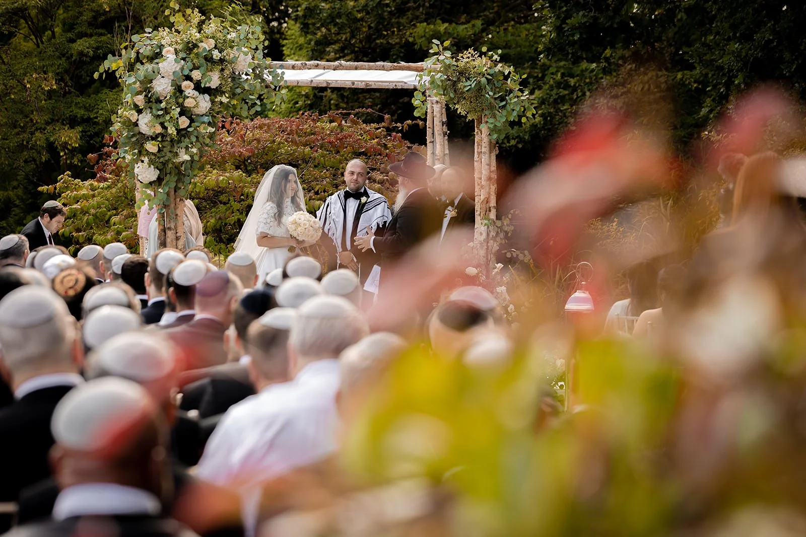 bride and groom exchange vows during outdoor wedding ceremony at nunsmere hall in cheshire