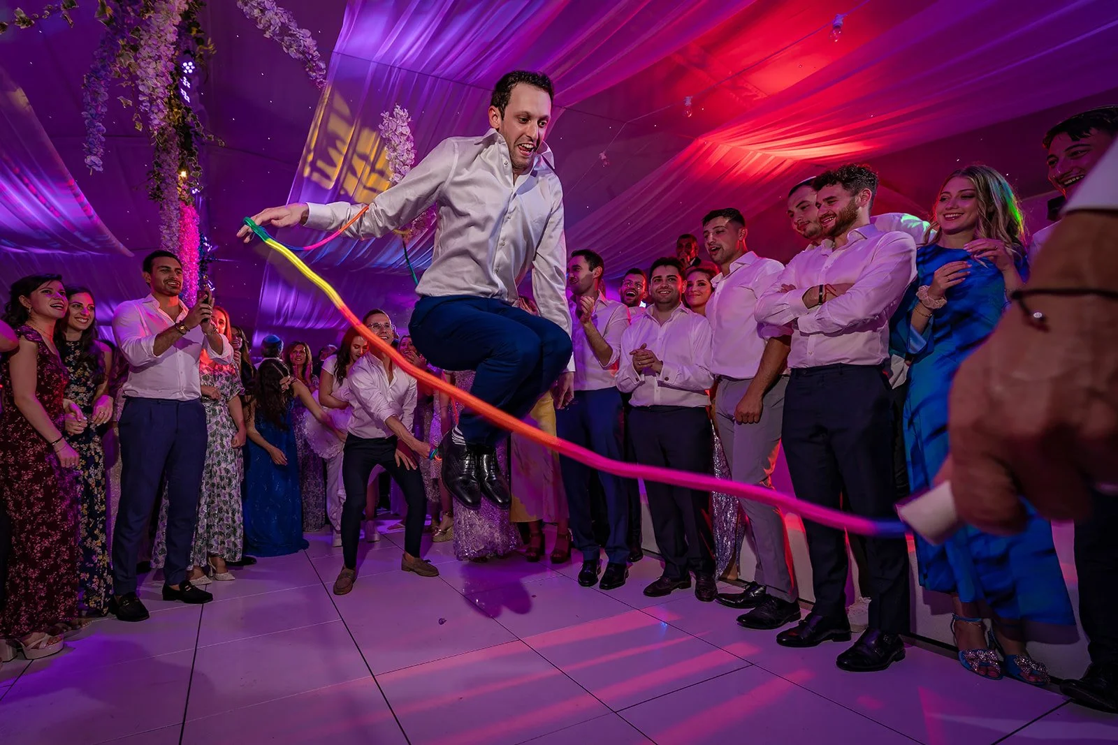 groom skipping during wedding evening reception at nunsmere hall venue in cheshire