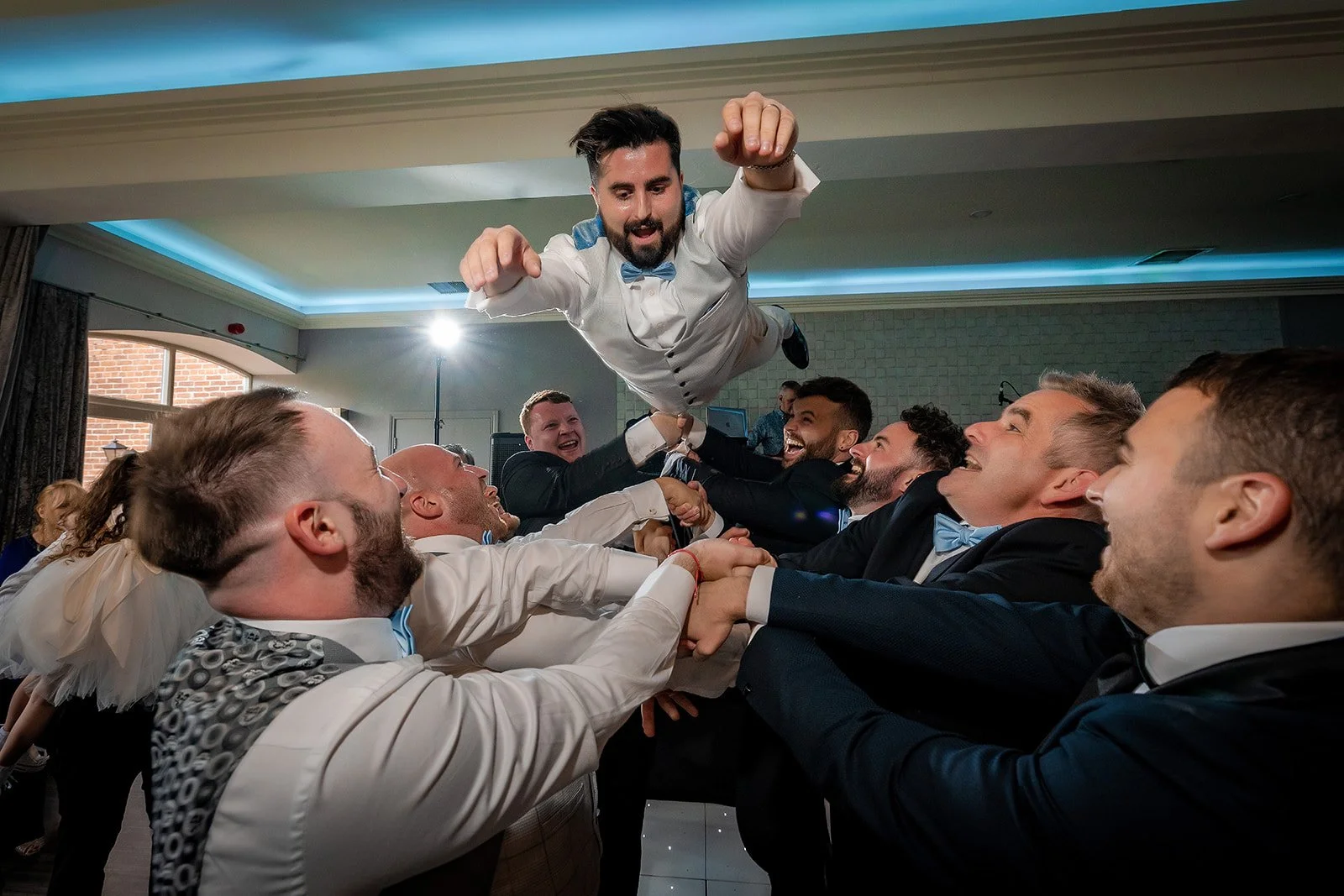 groom thrown in air on dance floor during wedding party at merrydale manor