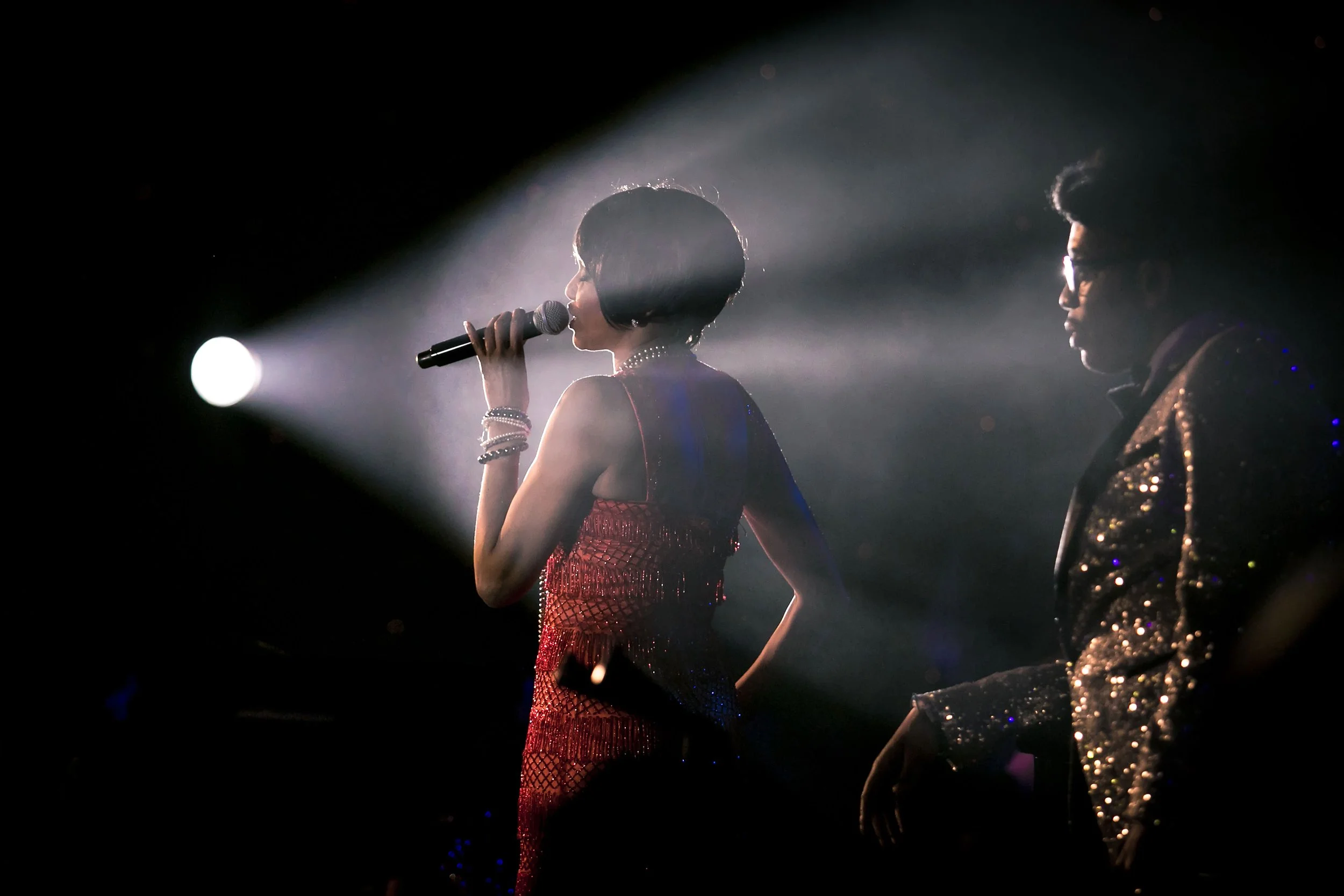 singer performing in spotlight at charity event in manchester