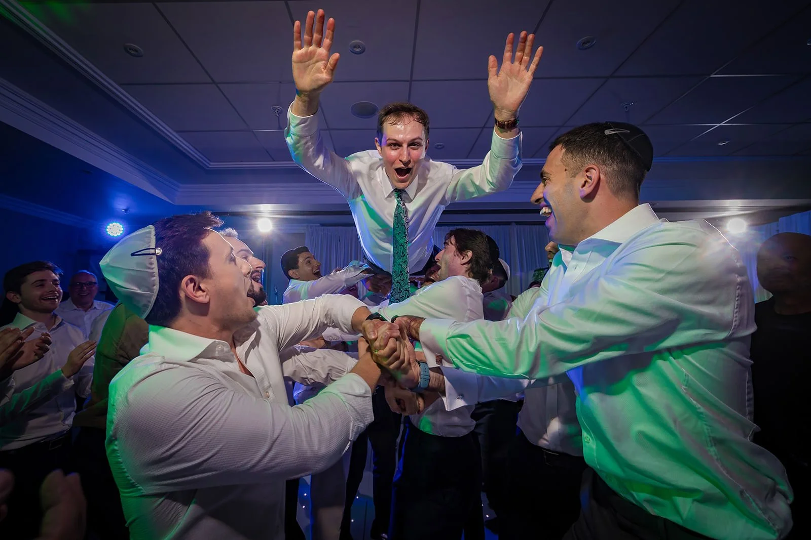 groom thrown in air by guests during reception party at worsley marriott hotel