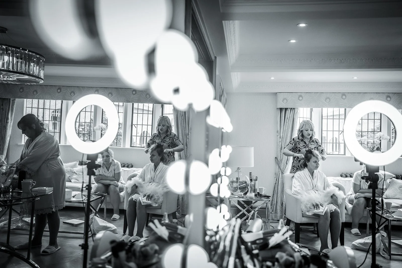 bride in mirror having make up done during bridal prep at Merrydale Manor in Cheshire