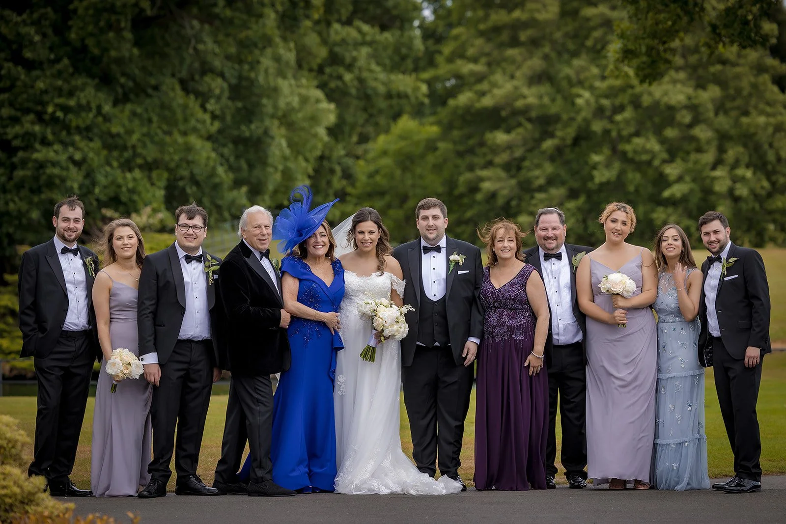 Merrydale Manor wedding guests gathered outdoors with bride visible – wedding photography Cheshire
