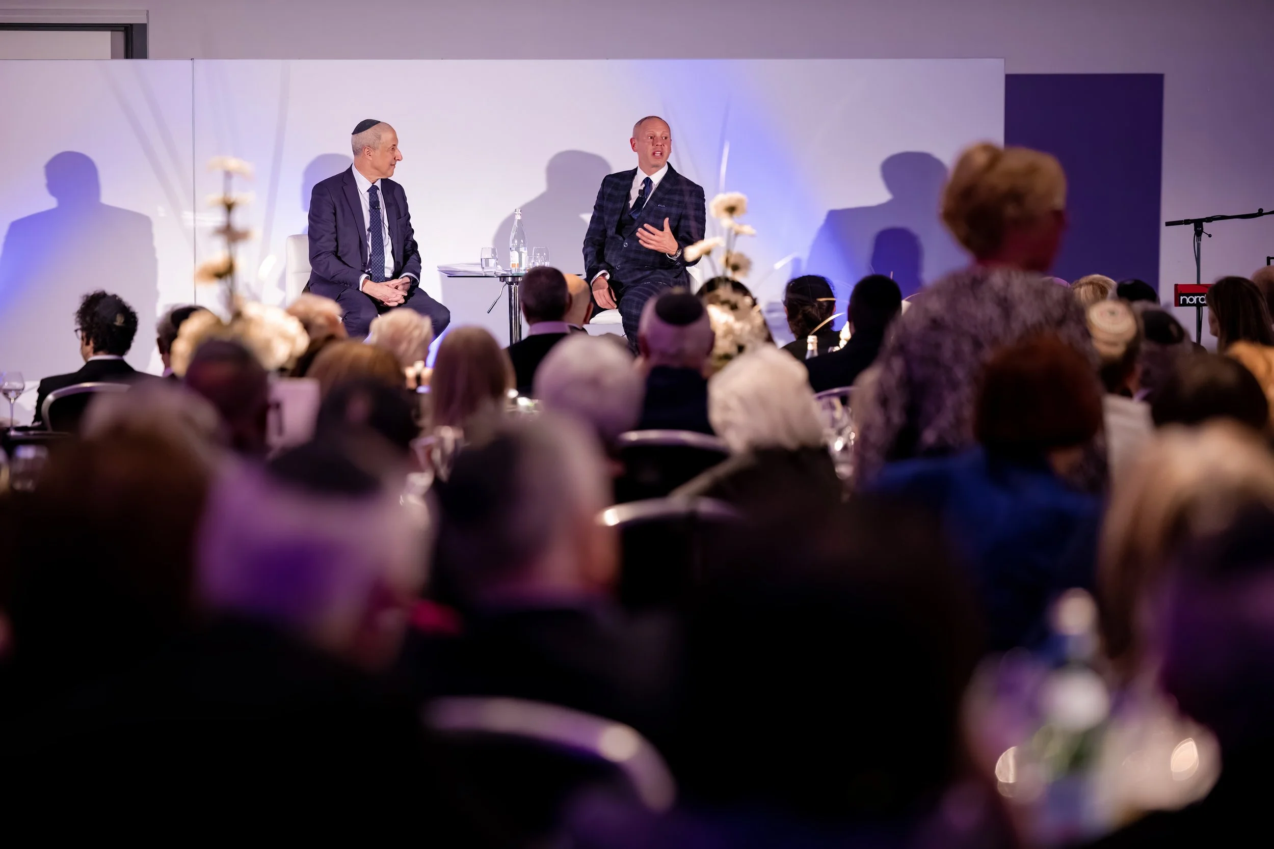 rob rinder chats on stage at a conference in Manchester