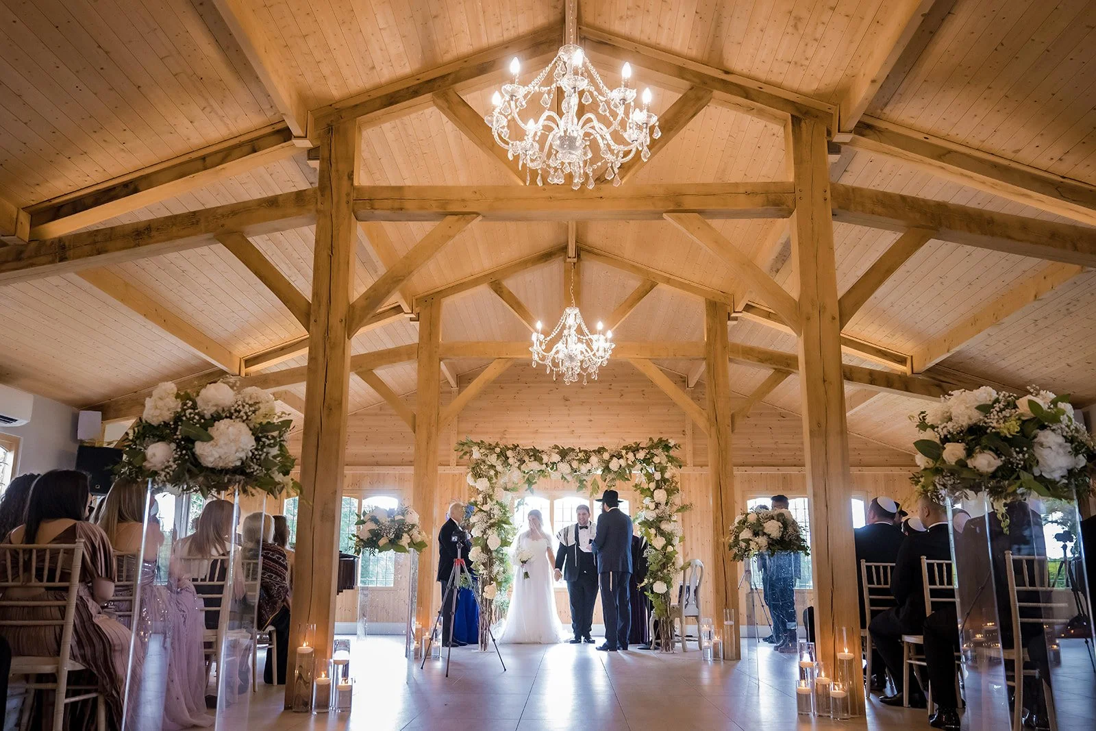 Merrydale Manor wedding ceremony at altar floral arch guests on wooden chairs – wedding photography Cheshire