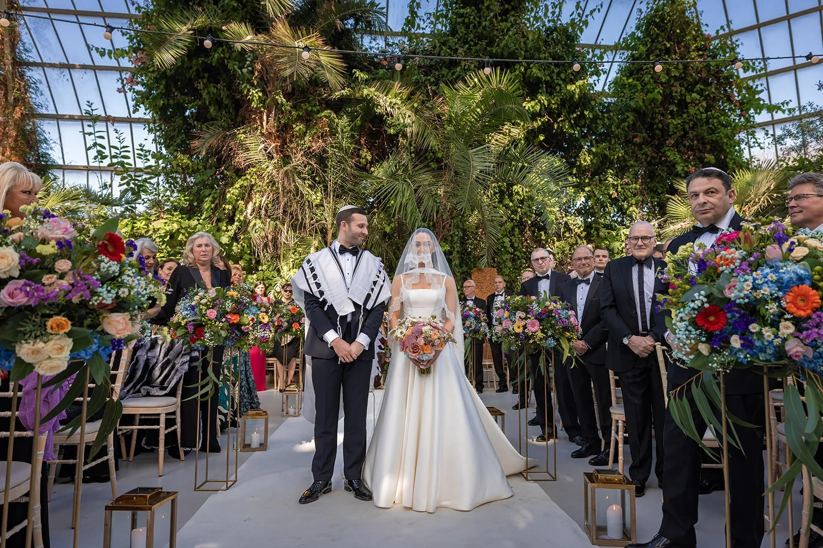 bride and groom standing in aisle at sefton park palm house wedding venue in liverpool