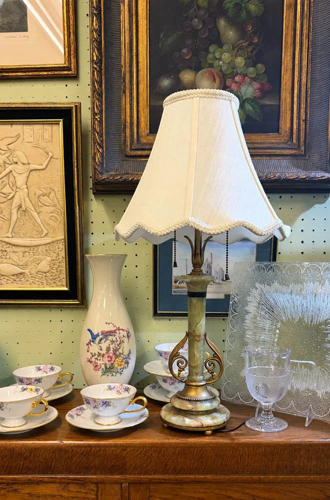 Green onyx table lamp with brass-colored scrolls and a scalloped shade in booth 128 at the Sherman Oaks Antique Mall