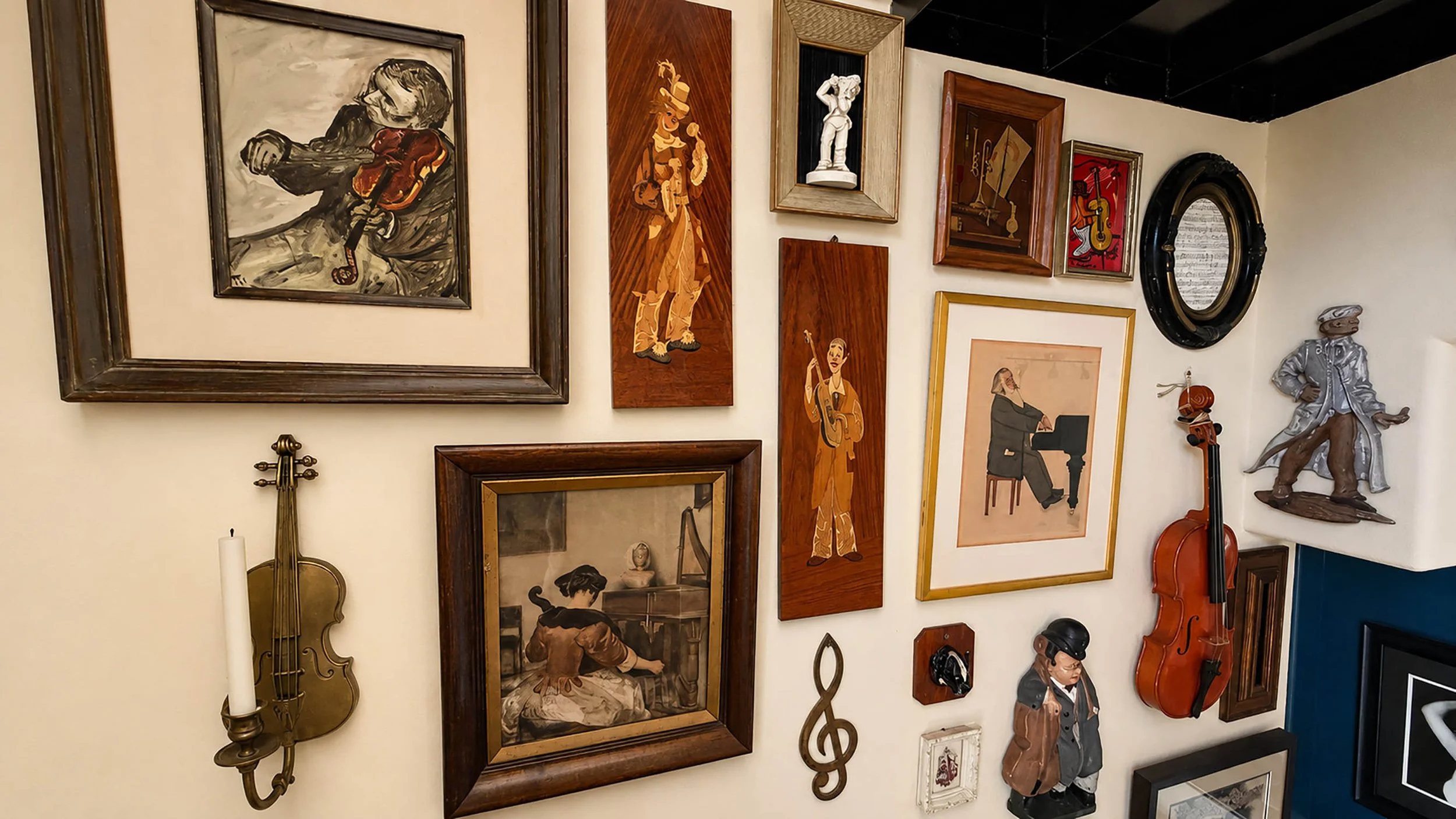 Music-themed gallery wall with vintage violin, marquetry panels, oil painting, and brass sconce on cream staircase wall