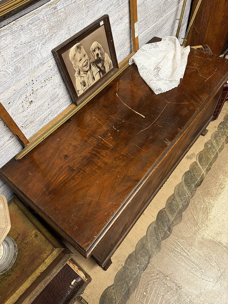 Deep pale scratches across the veneered top of a Lane cedar chest before restoration