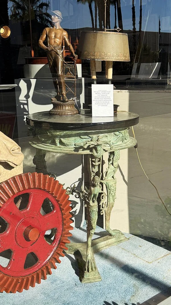 Verdigris bronze tripod table with winged figure legs and clawed feet, topped with black marble, styled after Pompeii antiquities