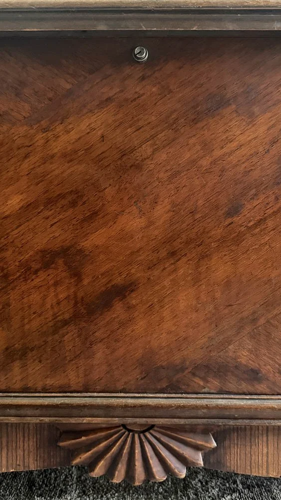 Restored diagonal wood veneer on the front of a 1934 Lane cedar chest, with a carved fan detail at the base