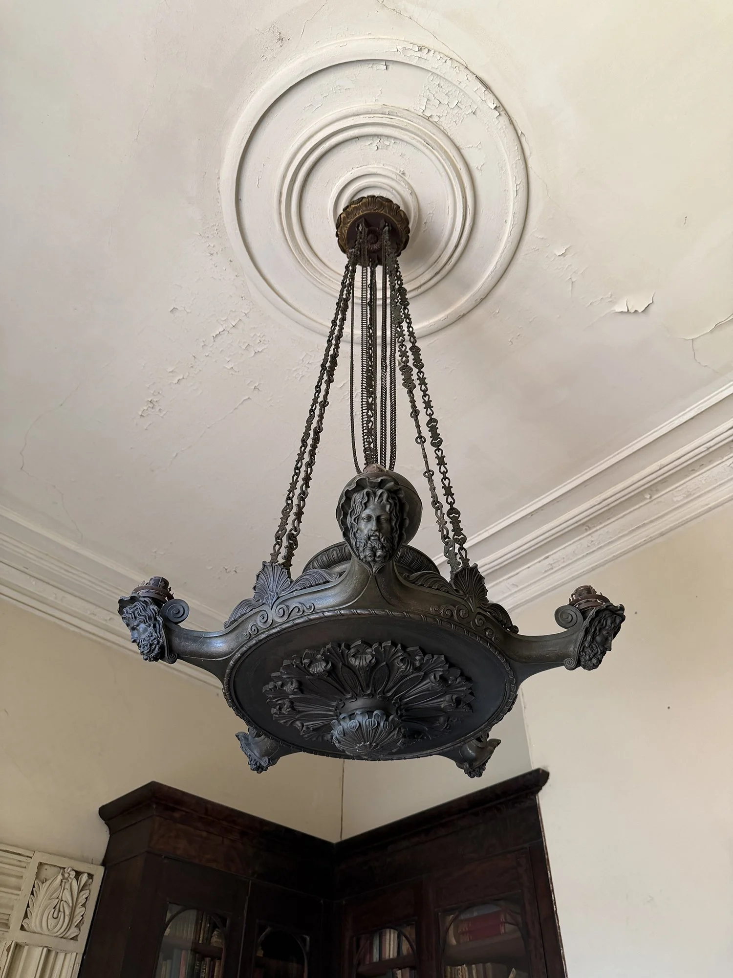 Antique bronze figural chandelier hanging in the front parlor of the Aiken-Rhett House in Charleston, South Carolina