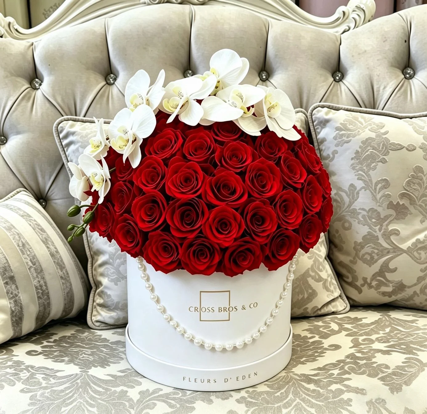A bouquet of red roses and white orchids in a white box with pearls, elegant, beautiful, expression of love