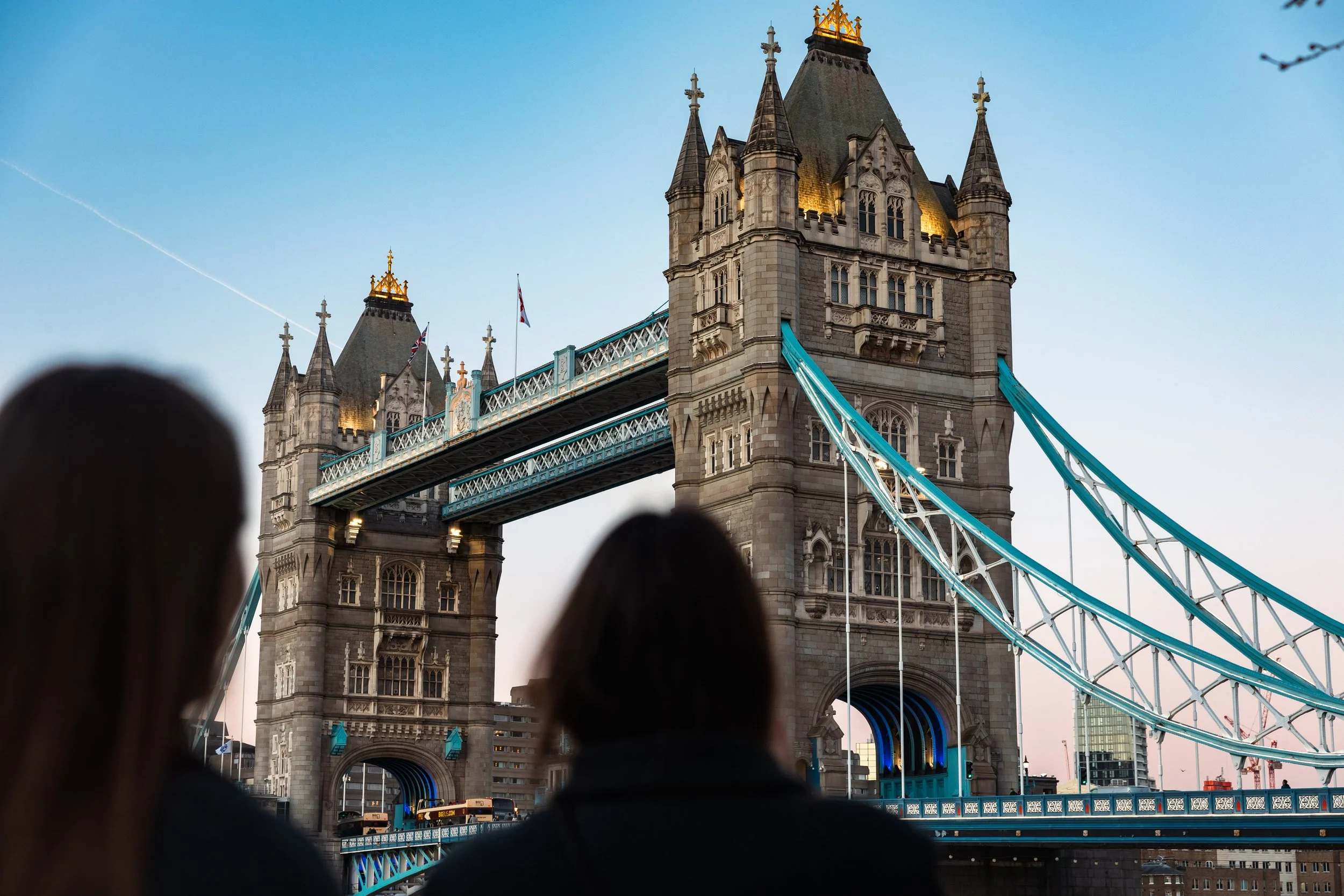 Tourists looking at Tower Bridge in London during sunset.
Taken in London