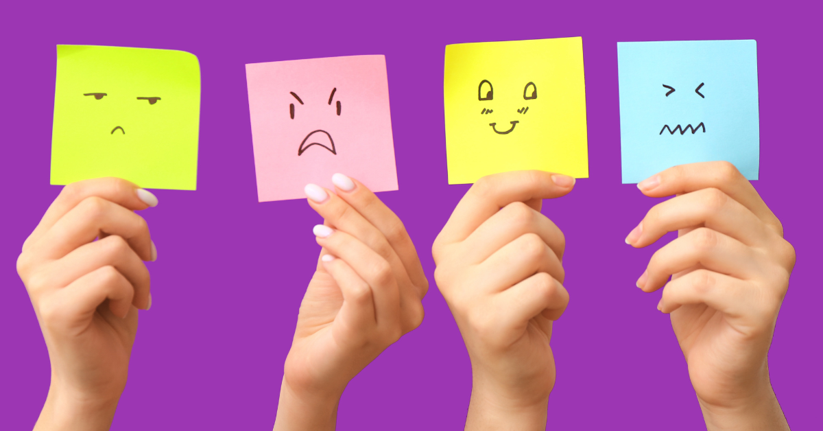 Four hands holding four colorful sticky notes with different facial expressions on a purple background.