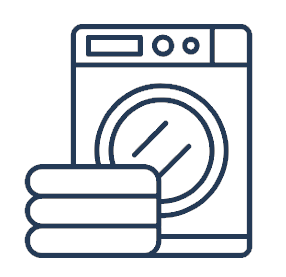An illustration of a washing machine with a stack of folded towels in front of it.