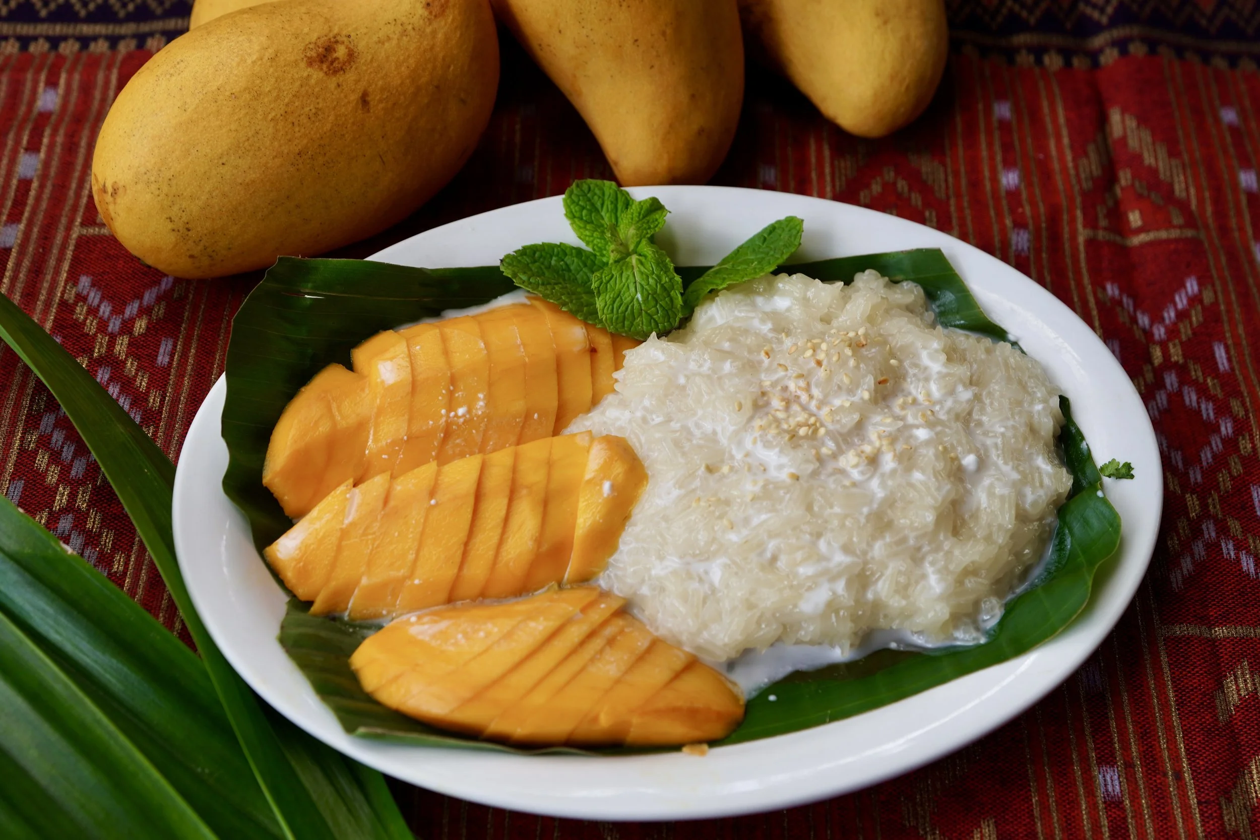 Our Mango Sticky Rice dessert-- freshly sliced mango, sticky rice, topped our homemade coconut sauce.