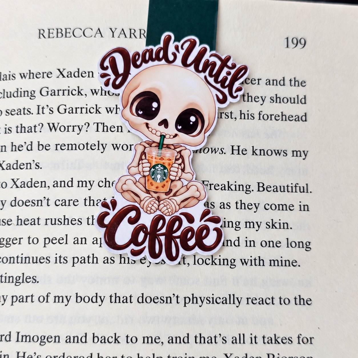 Double-sided magnetic bookmark featuring a smiling skeleton holding iced coffee, framed by the words “Dead Until Coffee.”