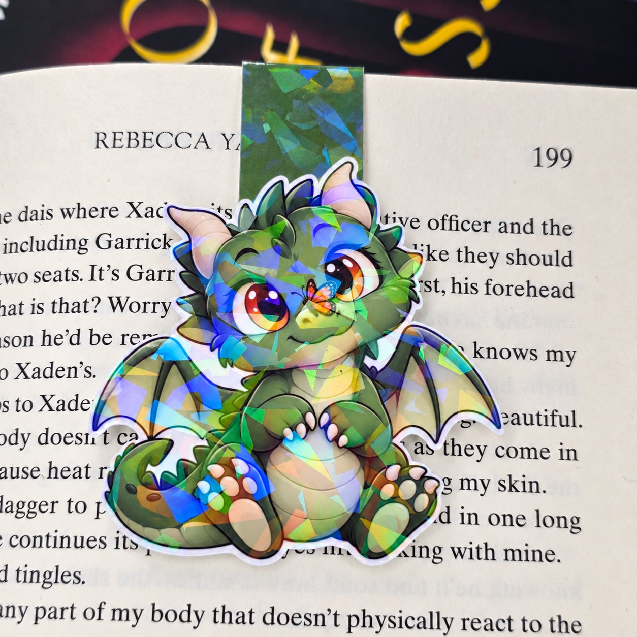 Holographic double-sided magnetic bookmark featuring a green baby dragon with an orange butterfly resting on its nose.