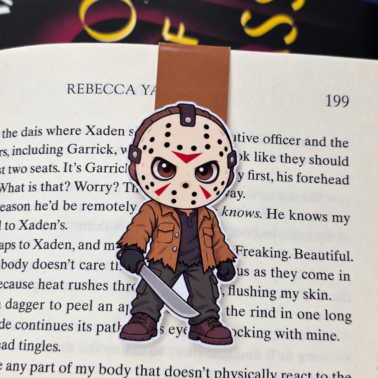 Double-sided magnetic bookmark featuring a cartoon Jason Voorhees wearing a hockey mask and brown jacket while holding a machete.