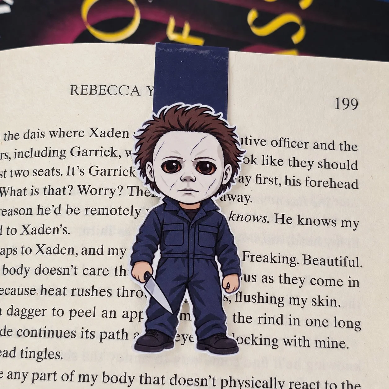 Double-sided magnetic bookmark featuring a cartoon Michael Myers wearing a white mask and navy coveralls while holding a knife.
