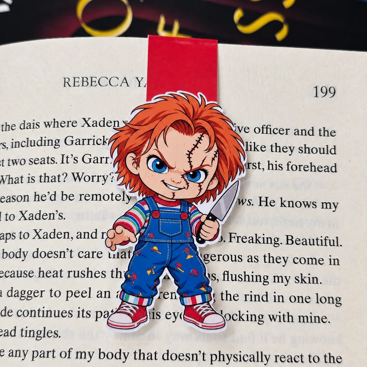 Double-sided magnetic bookmark featuring a cartoon Chucky with orange hair, stitched facial scars, striped sleeves, and blue overalls.