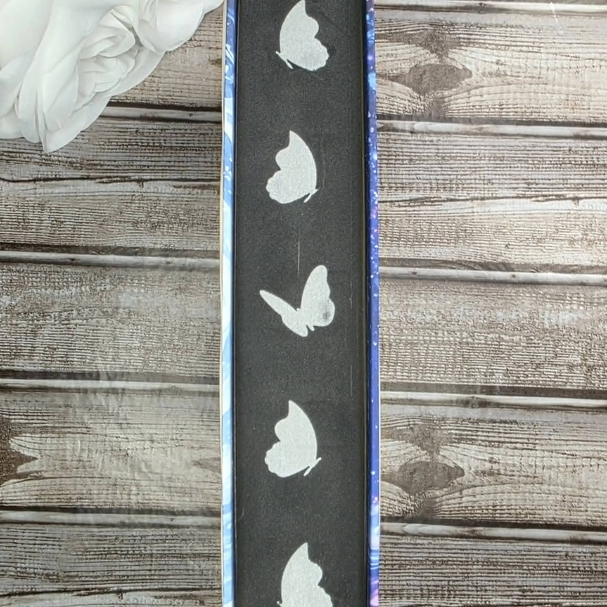 Black sprayed book edges with silver butterflies
