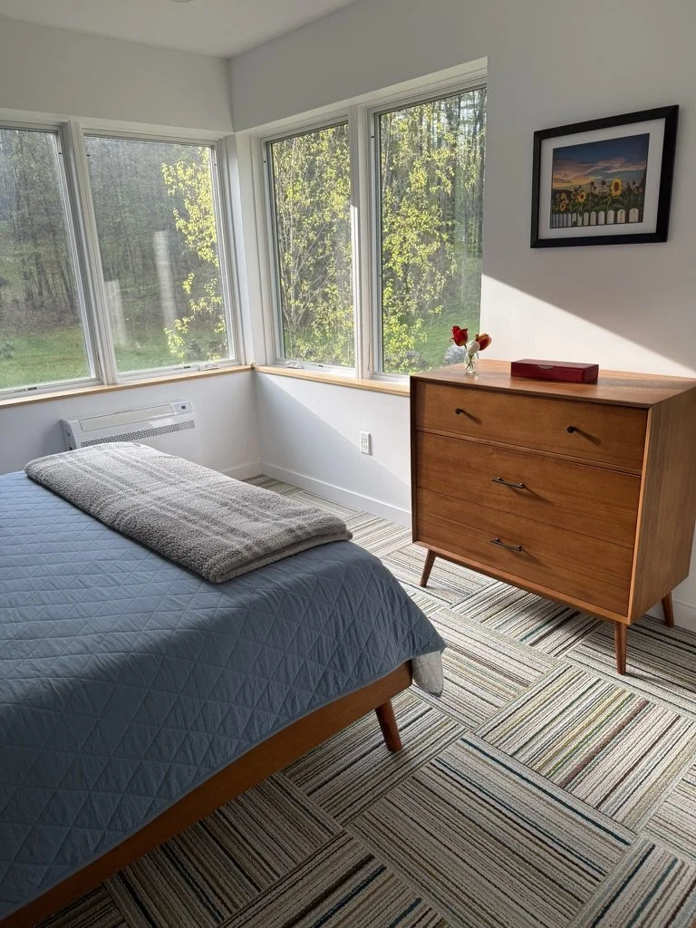 Upstairs bedroom with corner windows in mid-century modern home addition in Arlington, Vermont