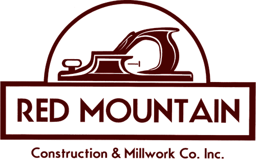 Logo of Red Mountain Construction & Millwork Co., Inc., featuring an anvil and a hammer.