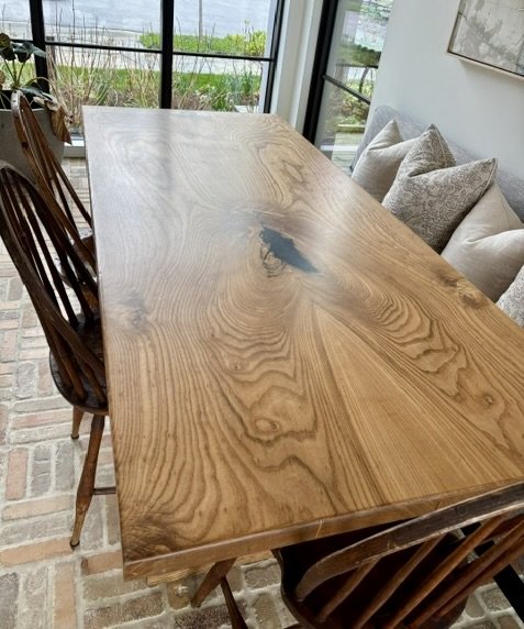 Detail view of custom walnut dining table by Red Mountain Construction in East Dorset, Vermont