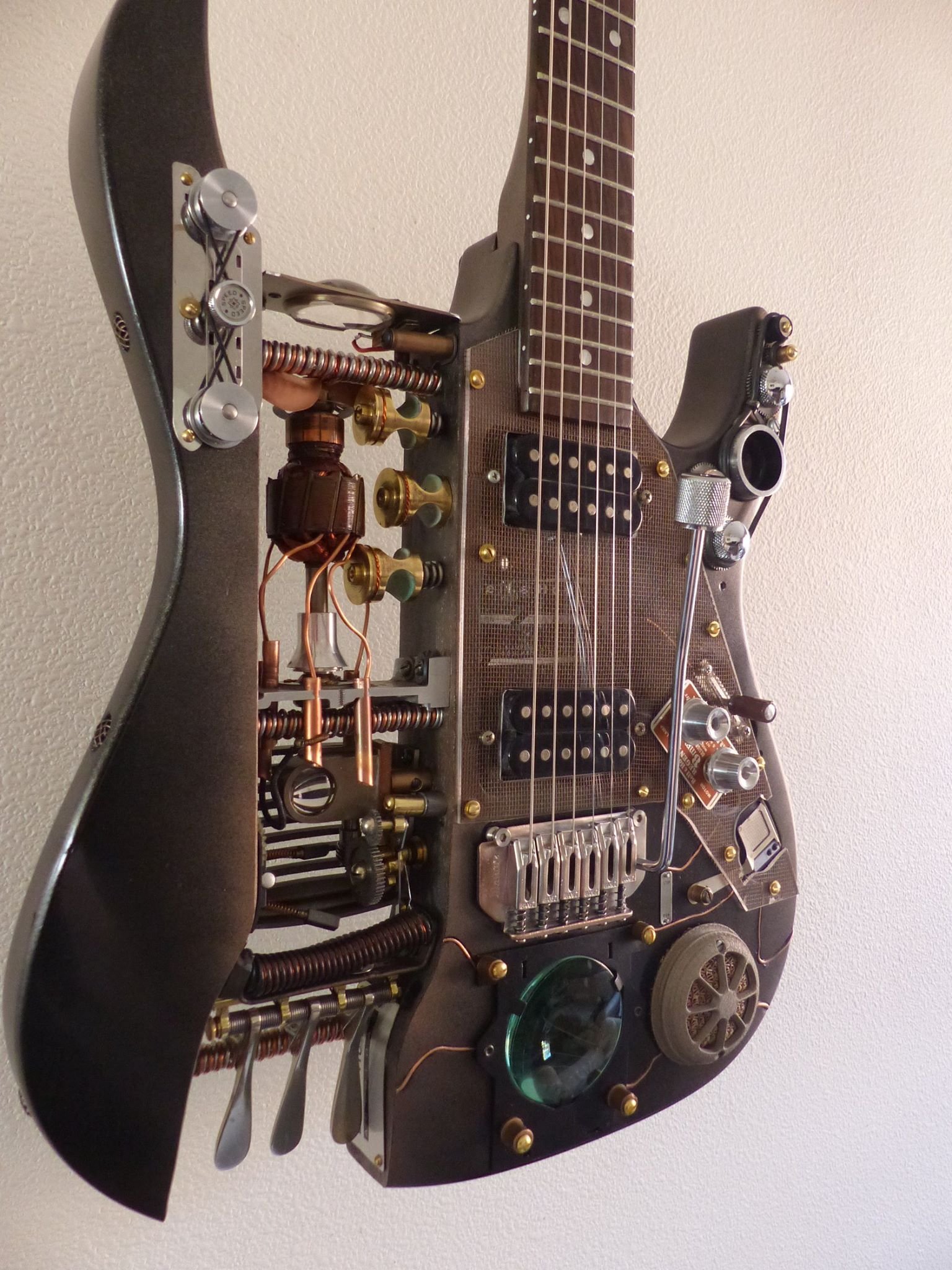 Steampunk Guitar made by Mike Moulton, Immortal Guitars, parts from vintage projectors, lenses, french horn keys, copper wiring 