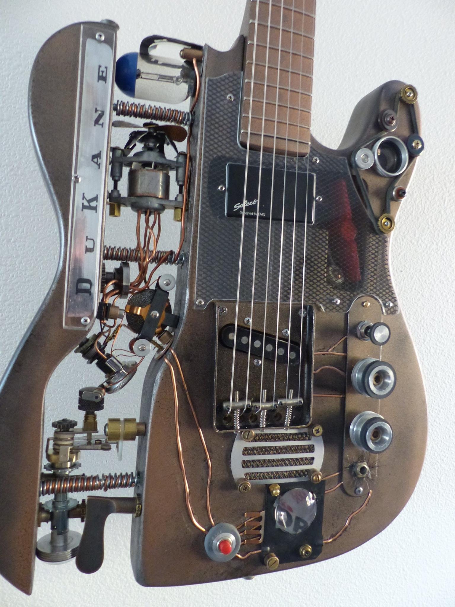 Steampunk Guitar, custom made by Mike Moulton, luthier at Immortal Guitars, using parts from vintage Dukane projector, camera and projector lenses, vintage parts.