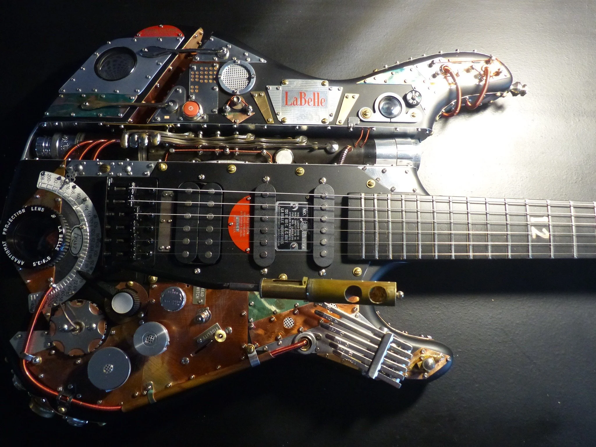 Steampunk Guitar by Mike Moulton at Immortal Guitars, vintage parts from LaBelle 55 projector, labels, lenses, custom made, one of a kind, kalimba, clarinet, lyre