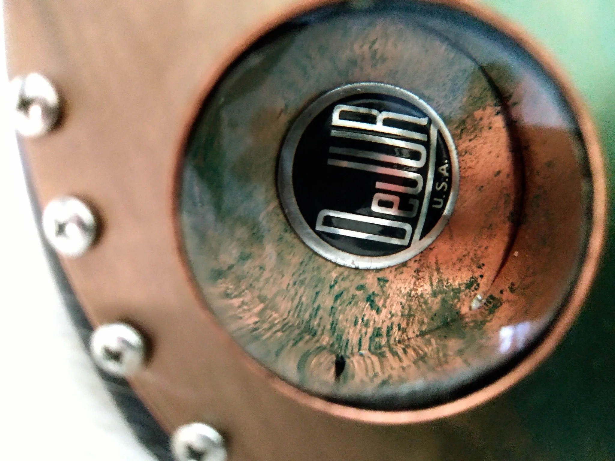 closeup detail of the Blue DuJur steampunk guitar, Immortal Guitars, Mike Moulton, luthier, made from vintage 8mm projector, labels, lenses, misc. parts from projector, trumpet pieces, lyre.