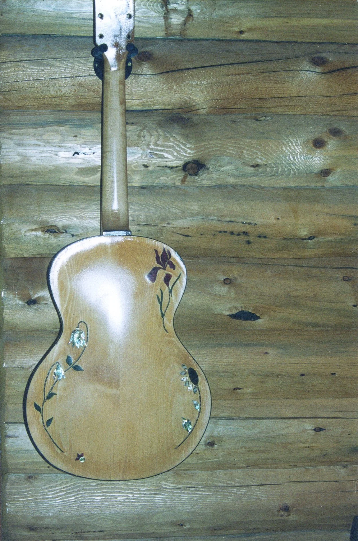 Custom hand carved archtop guitar, with inlay of mother of pearl, abolone, exotic wood. Maple back, neck, sides. One of a kind made by Elaine Moulton, luthier at Immortal Guitars.