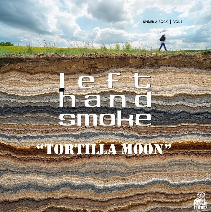 Cross-section of layered rock formations with a person walking and holding an umbrella on the surface. Overlaid text reads: "left hand smoke 'TORTILLA MOON'" and small text at the top says "UNDER A ROCK | VOL 1."