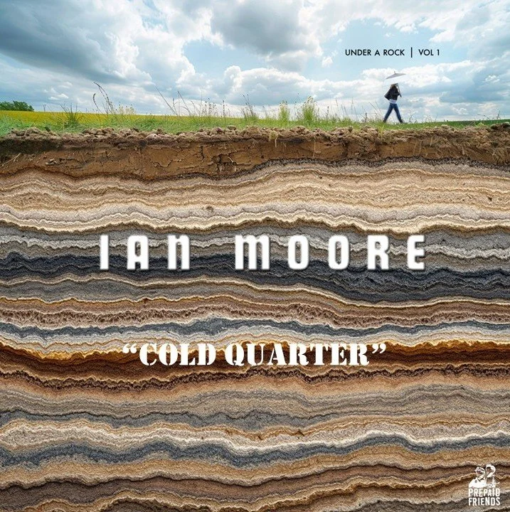 A book cover featuring layers of rock through a cross-section view with a person walking on the surface holding an umbrella. Text on the cover reads "Under a Rock Volume 1" and "Ian Moore" with the title "Cold Quarter".