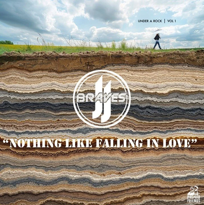 Cross-section of layered rocks with a person walking on the surface holding an umbrella in a cloudy sky, and text reading 'Under a rock Vol. 1', 'J Braves', and the quote 'Nothing like falling in love'
