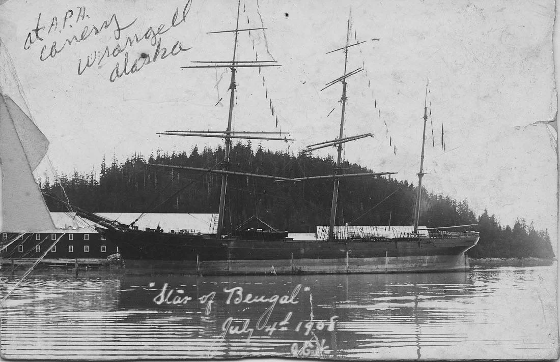 Black and white photo of a sailing ship named 'Star of Bengal' docked in a harbor with trees in the background. Handwritten notes indicate it was visited by the 'Wrecking Alaska' on July 4, 1905.