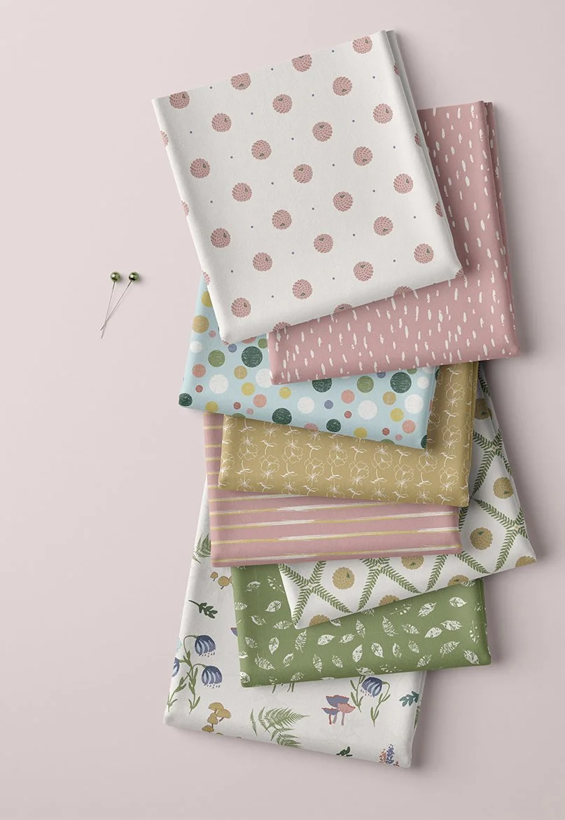 Whispering Wilds fabric collection by Flourish & Bloom Designs, featuring coordinating botanical and nature-inspired surface patterns in soft pink, green, blue and ochre.