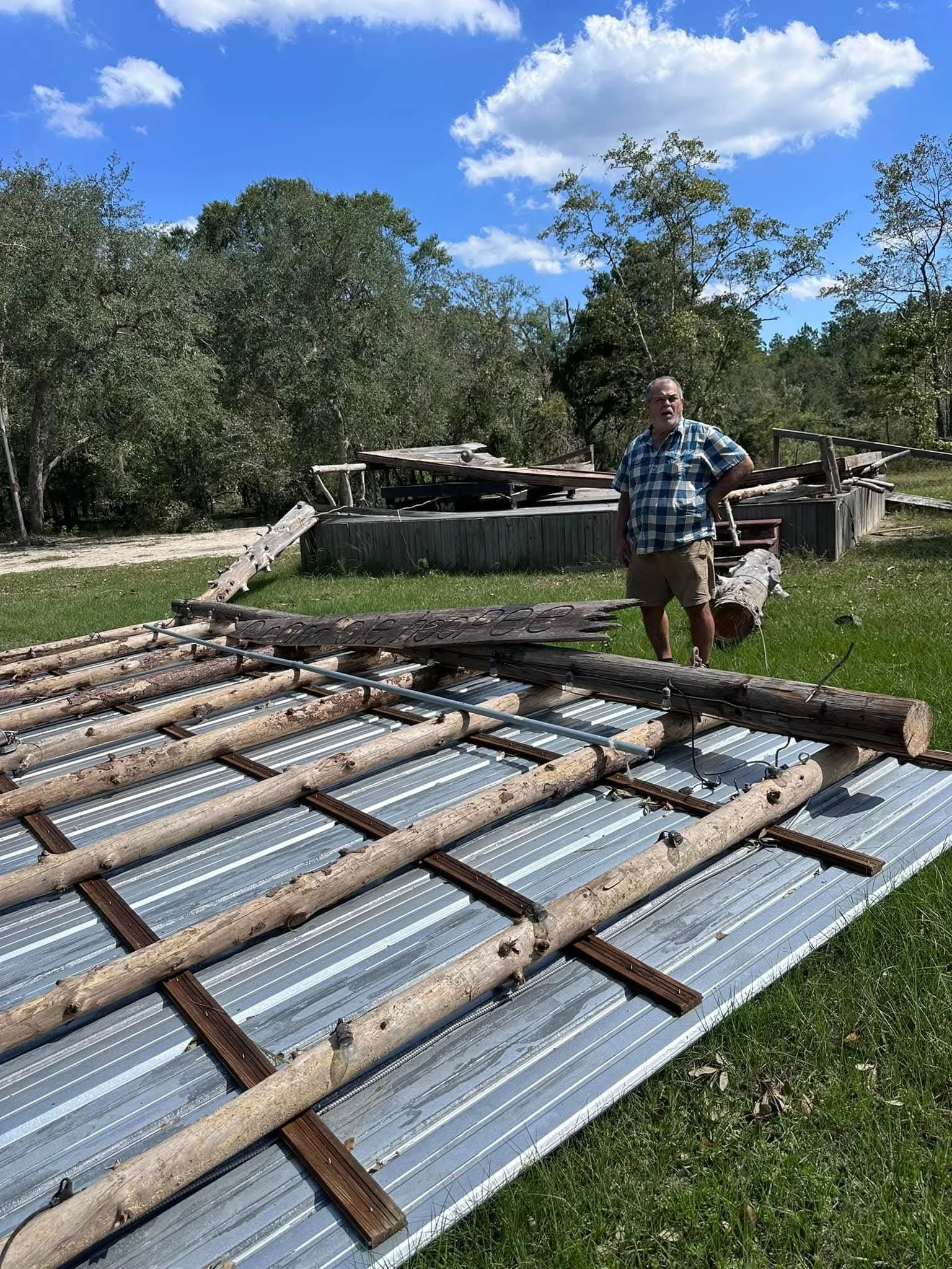 Mr. Billy standing among the debris of the damaged stage.