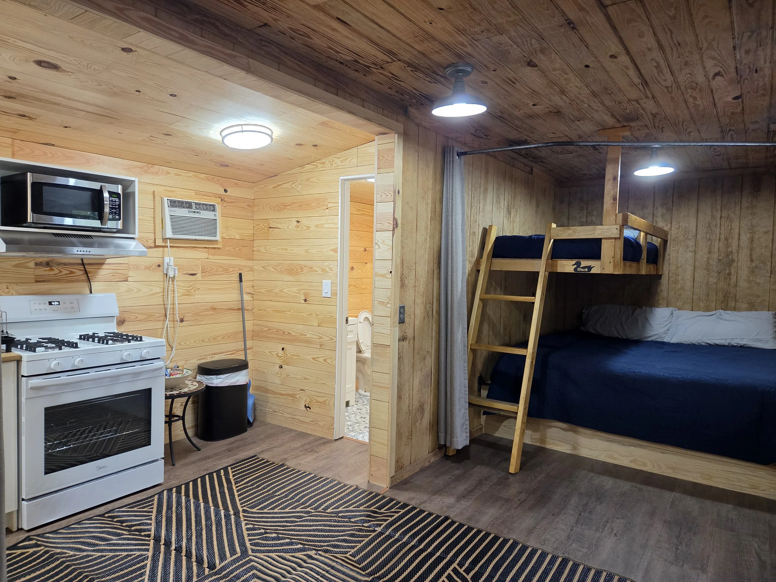 Newly remodeled Coyote Den cabin, showing beds, kitchen, & bathroom addition. 