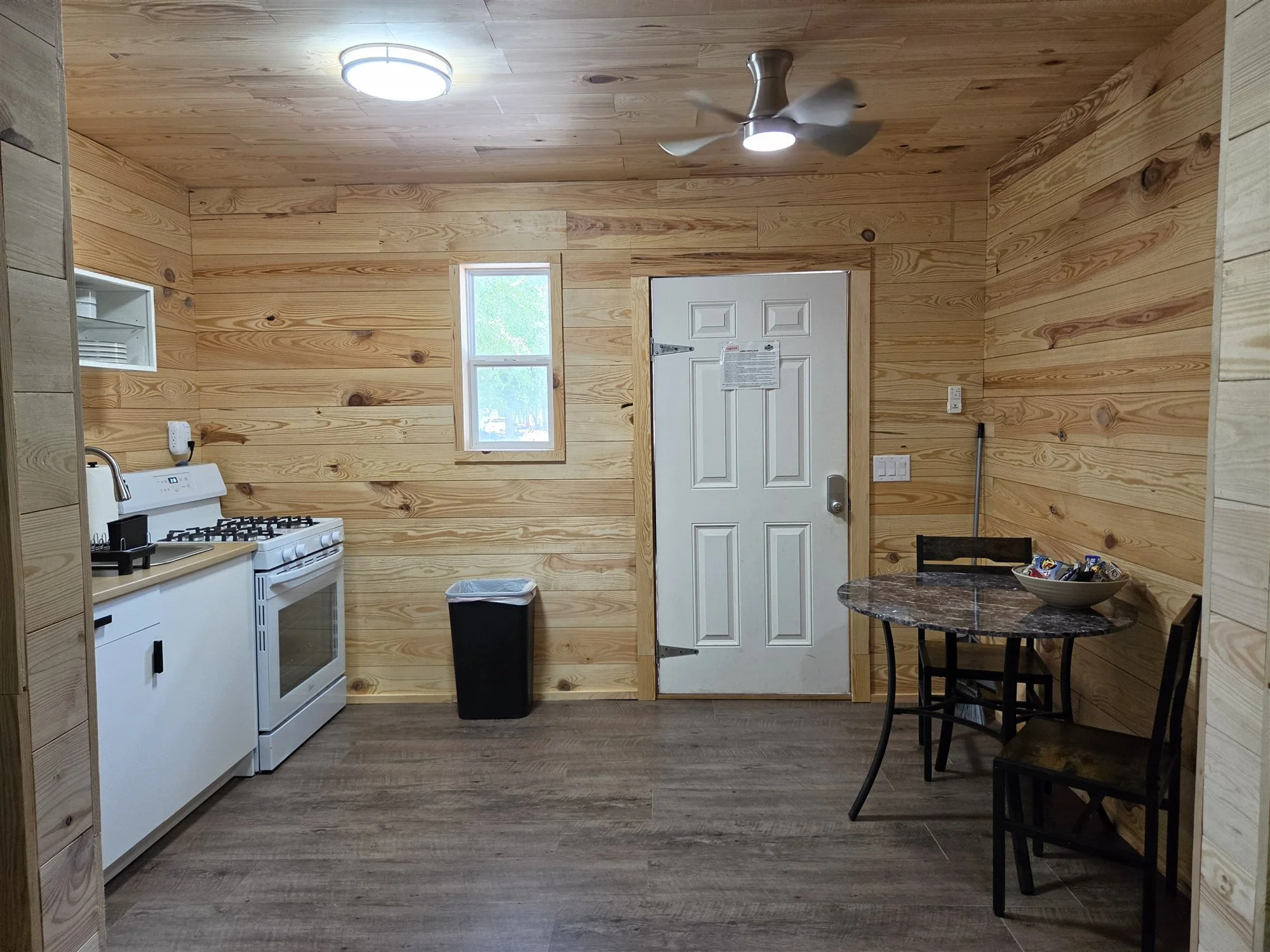 Inside view of The Beaver Den Cabin (remodeled) showing the kitchenette and dining table