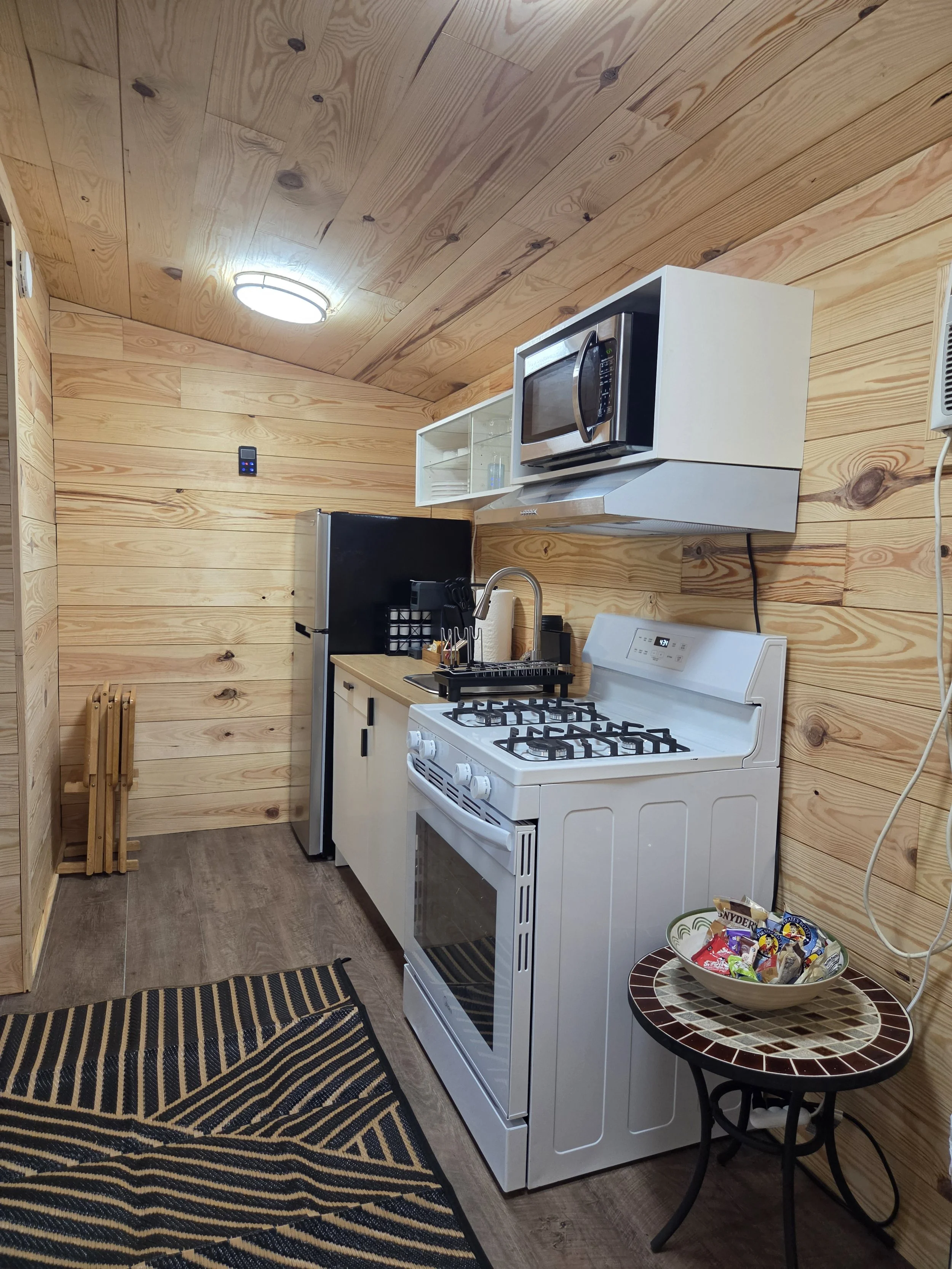 Newly remodeled Coyote Den cabin, showing beds, kitchen, & bathroom addition. 