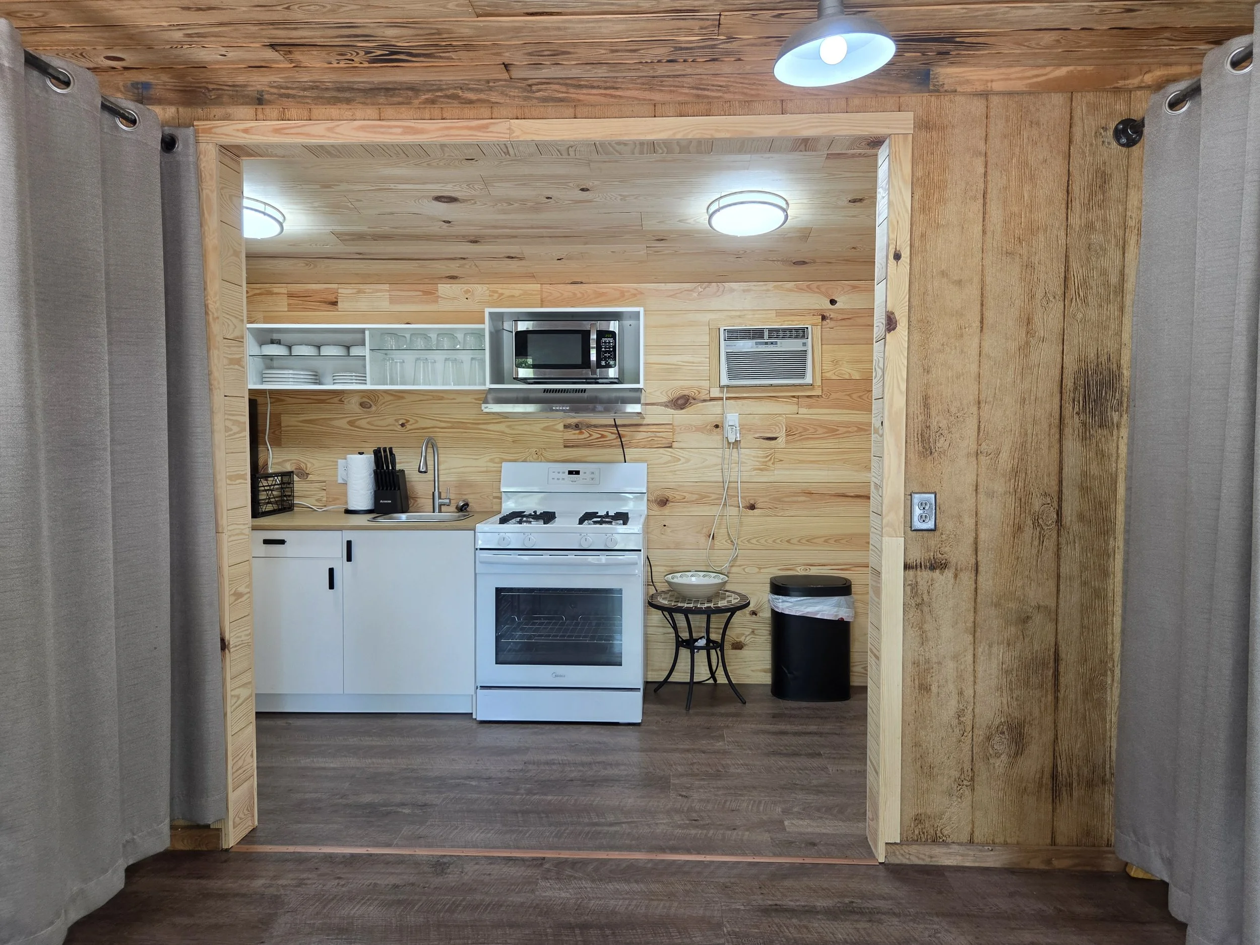 Newly remodeled Coyote Den cabin, showing beds, kitchen, & bathroom addition. 